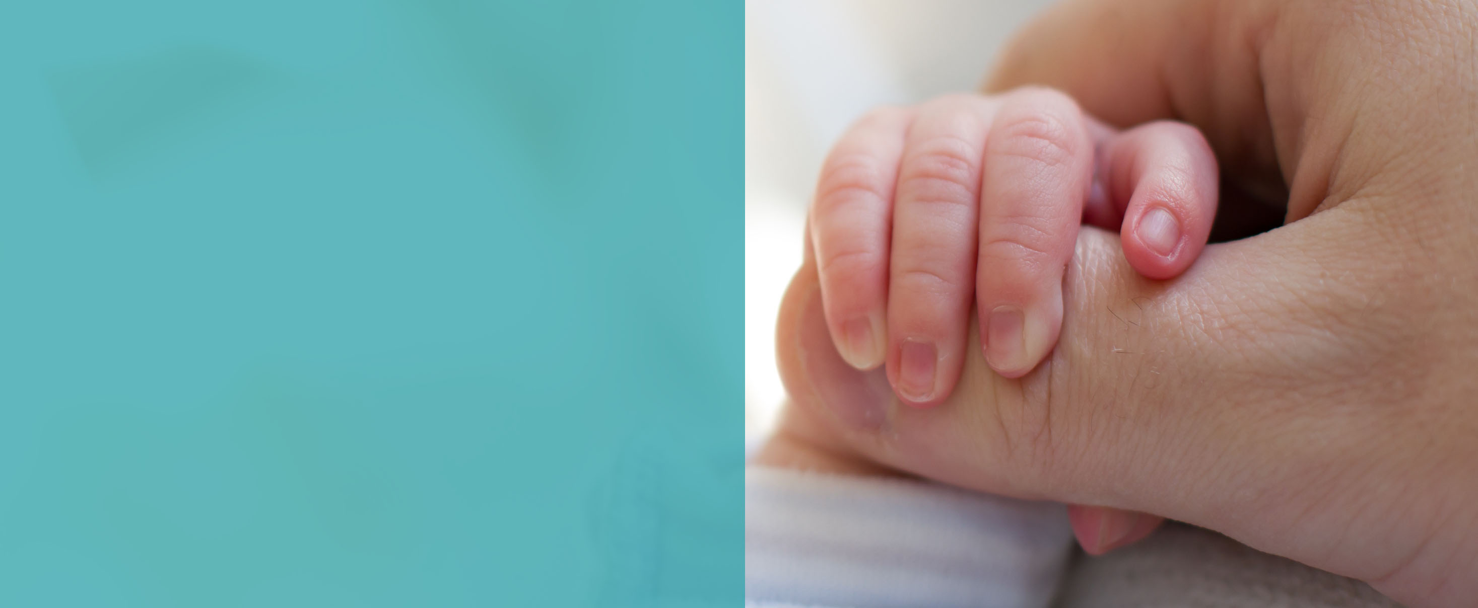 Newborn baby touching his mother hand